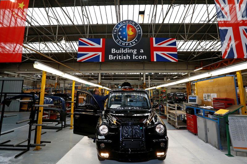 A worker checks a TX4 at the end of the
