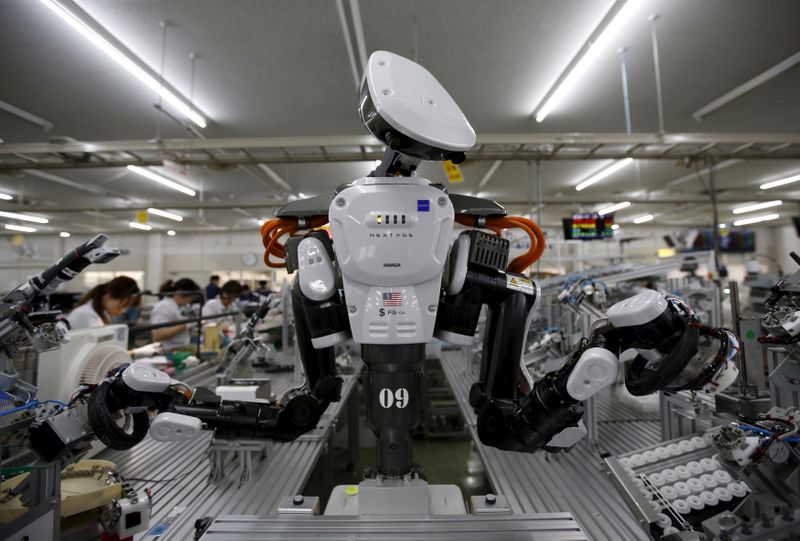 FILE PHOTO: A humanoid robot works side by side with