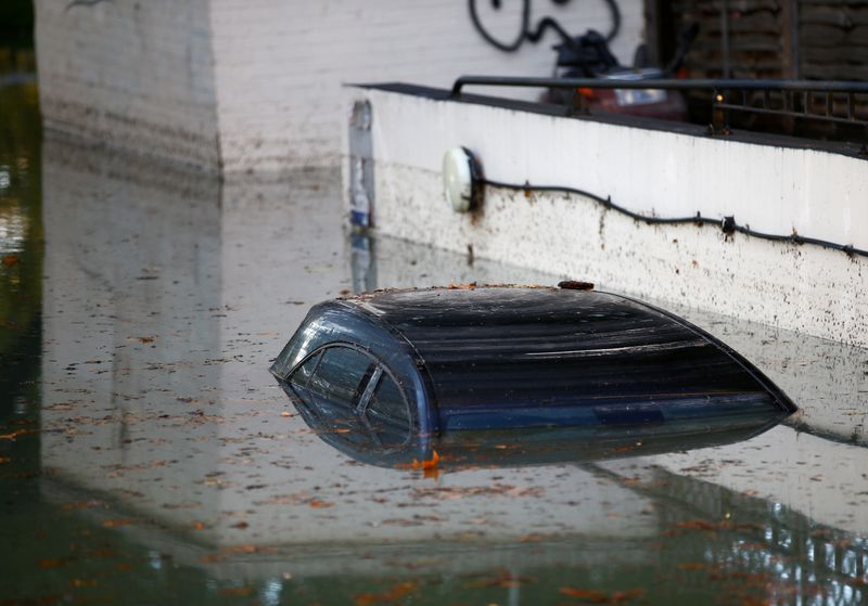 FILE PHOTO: A car is submerged after a water supply