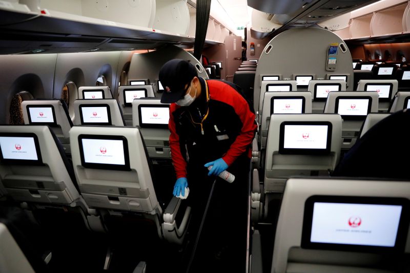 FILE PHOTO: A staff member of Japan Airlines wearing a