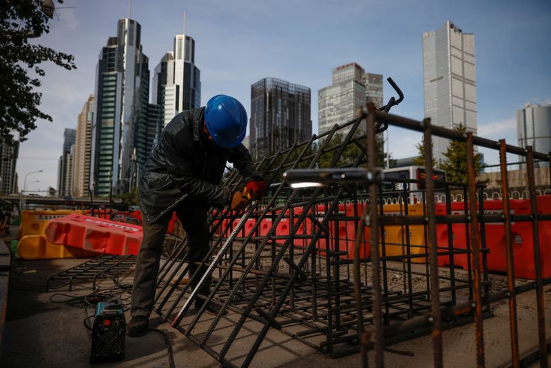 Workers prepares an iron grid for welding at a construction