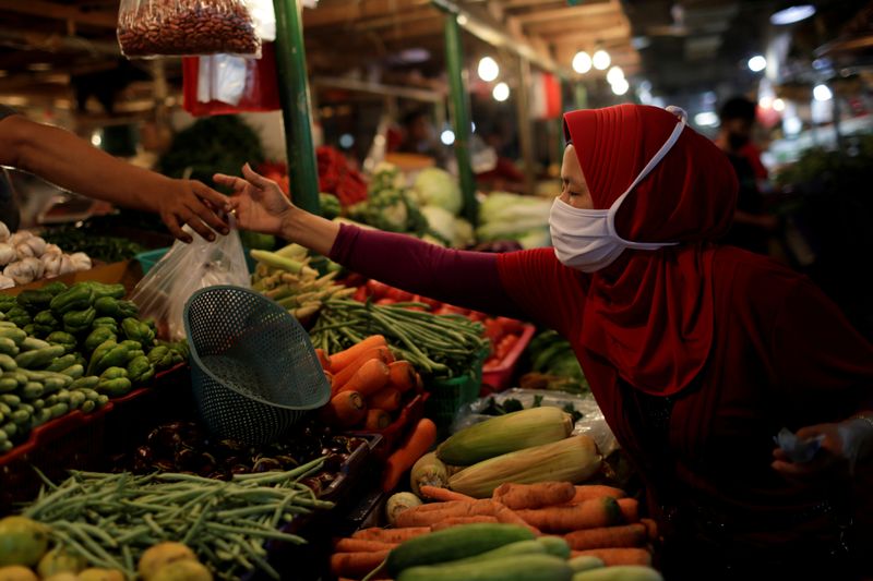 FILE PHOTO: A woman wearing a protective mask shops for