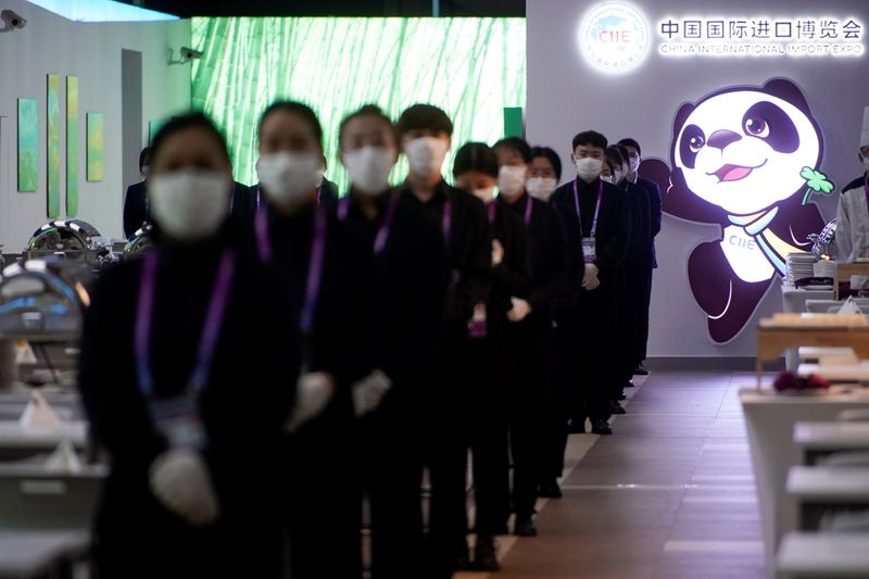 Staff members wearing face masks are seen at the third