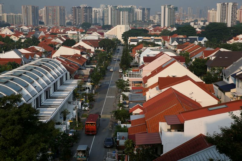 FILE PHOTO: Vehicles pass private landed residential properties at a