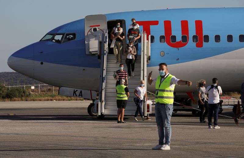 FILE PHOTO: Passengers on a TUI Airways flight arrive at