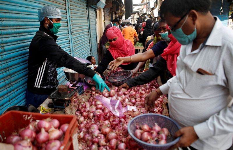 FILE PHOTO: People buy onions at Mumbai market
