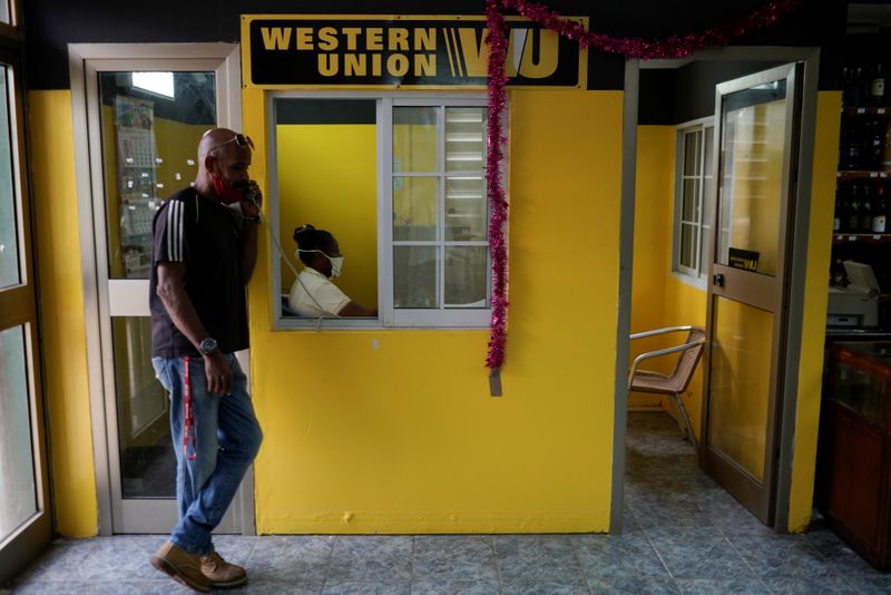 A man talks on the phone outside a Western Union
