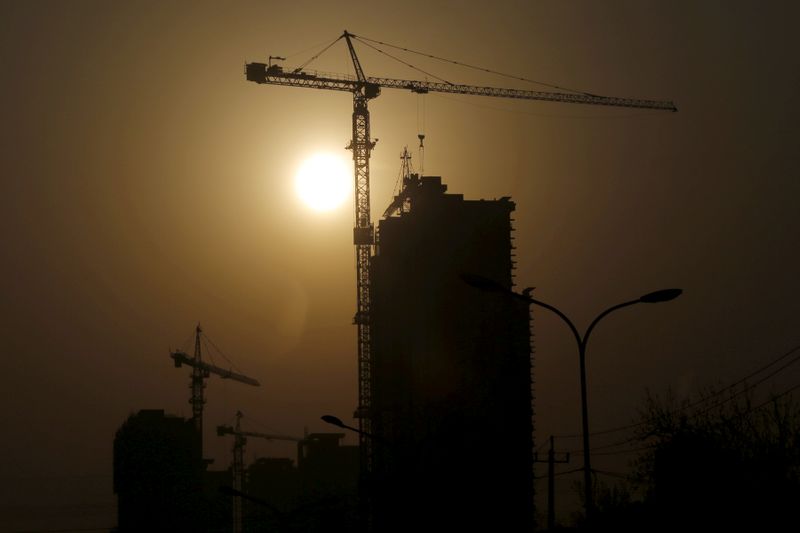 FILE PHOTO: A crane at a construction site is silhouetted