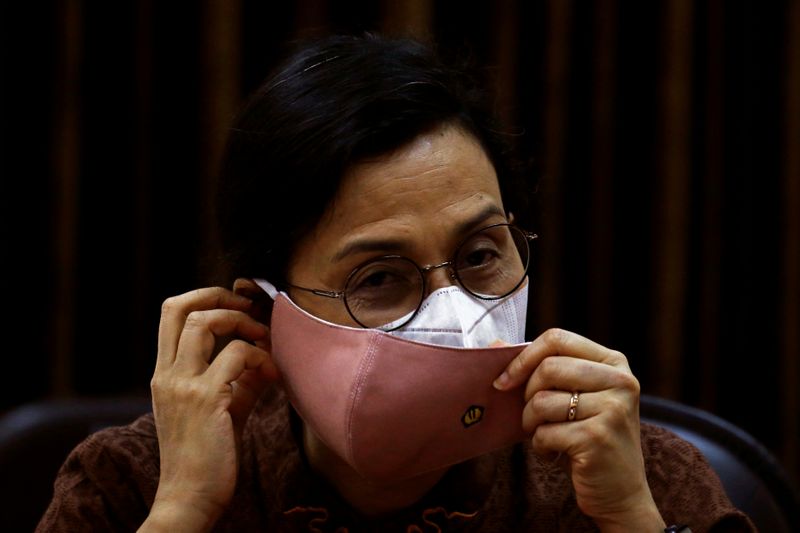 Indonesian Finance Minister Sri Mulyani wears protective masks during an