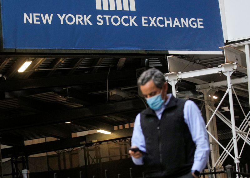 A New York Stock Exchange employee uses his phone on