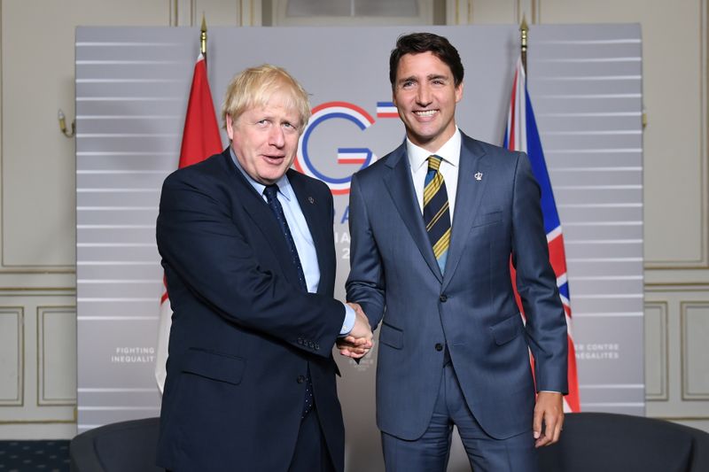 FILE PHOTO: PMs Johnson and Trudeau at G7 summit 2019