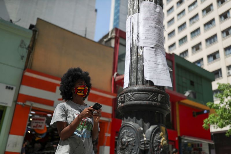FILE PHOTO: A woman looks at job listings posted on