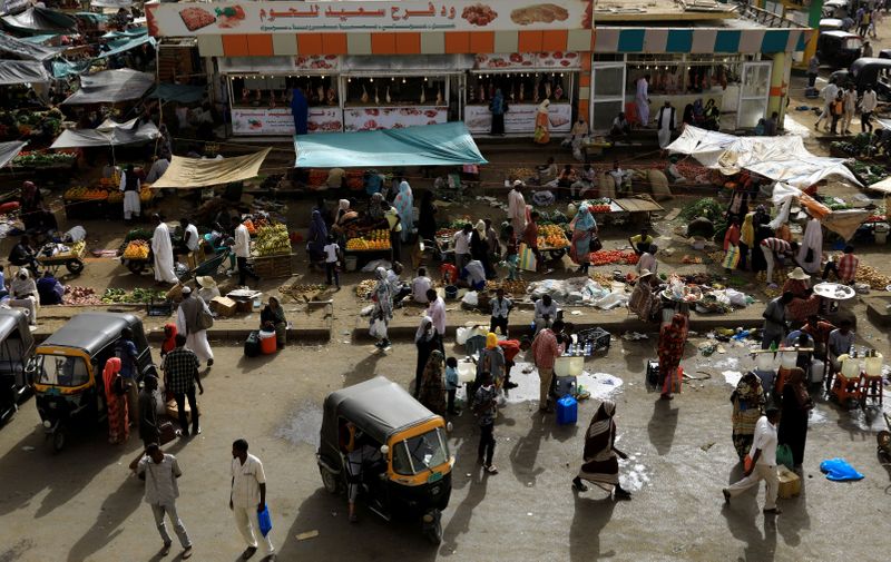 FILE PHOTO: Sudanese residents shop in a bazaar in Khartoum