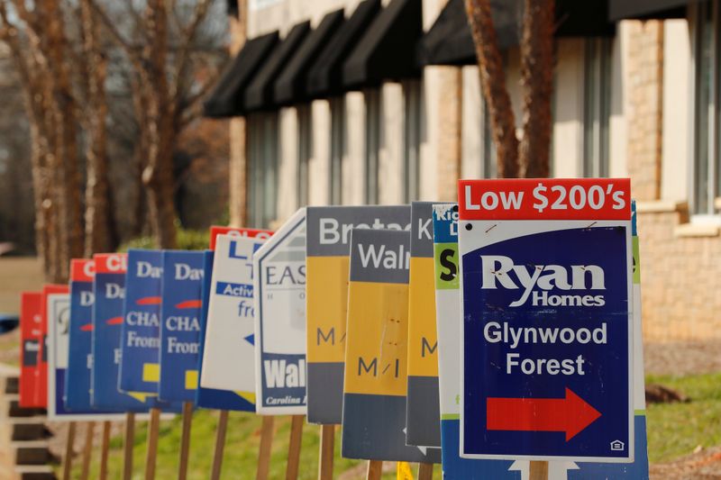 FILE PHOTO: Real estate signs advertise new homes for sale