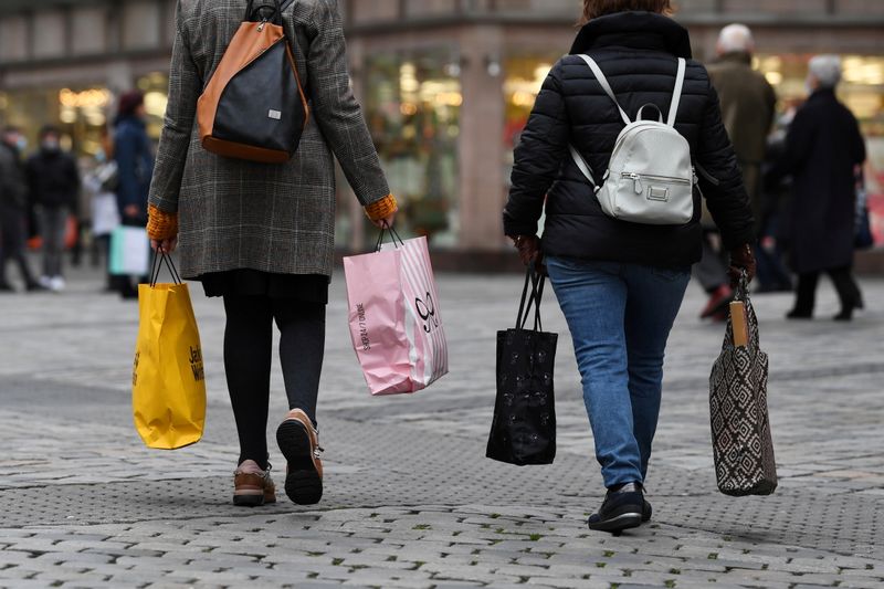 FILE PHOTO: Women with shopping bags walk through the city