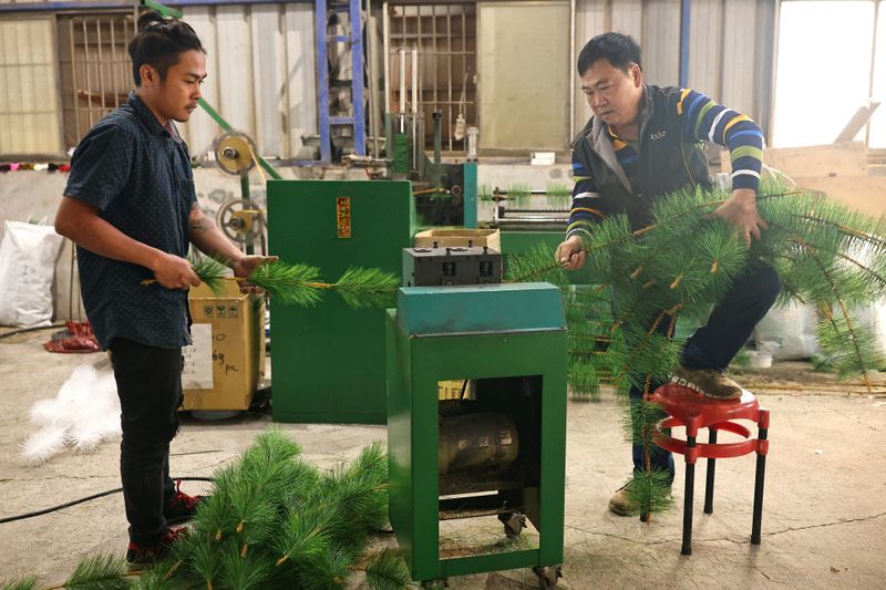 FILE PHOTO: Staff produce parts of a Christmas tree at