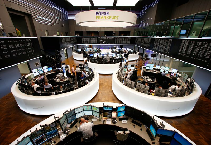 FILE PHOTO: Traders work at their screens in front of