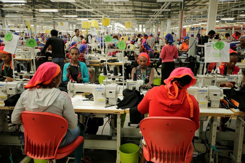 FILE PHOTO: Workers sew clothes inside the Indochine Apparel textile