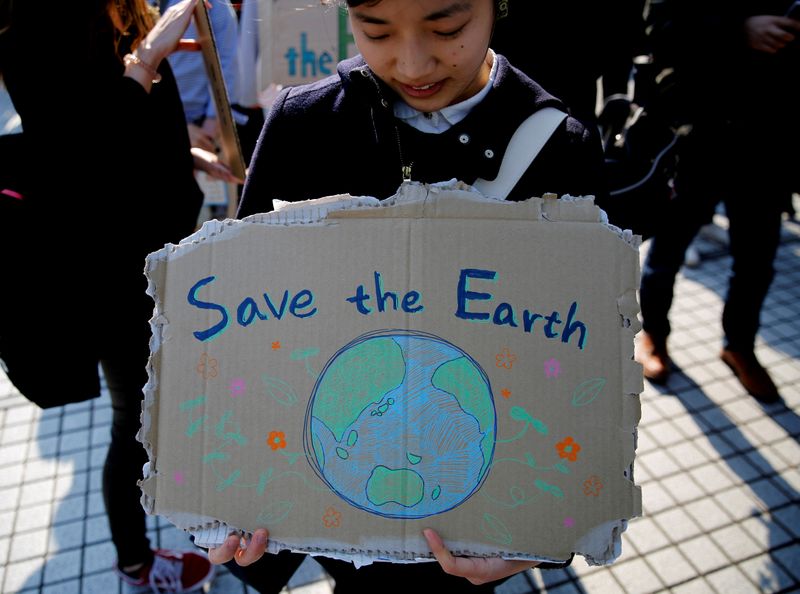 FILE PHOTO: A school student holds a sign as she