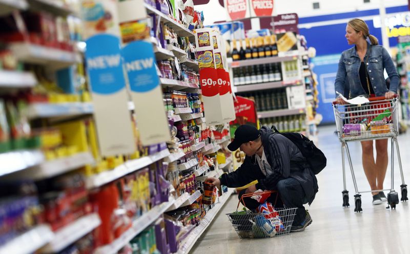 FILE PHOTO: Shoppers browse aisles in a supermarket in London