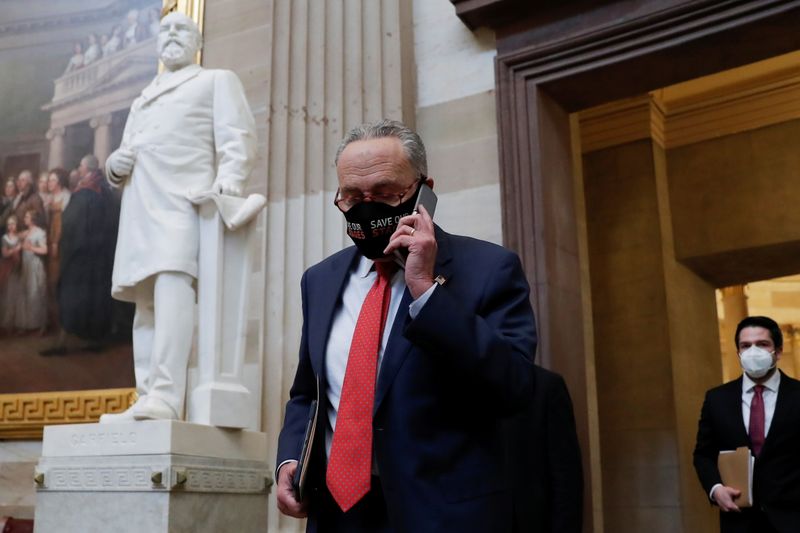 Senate Minority Leader Schumer speaks on a cell phone before