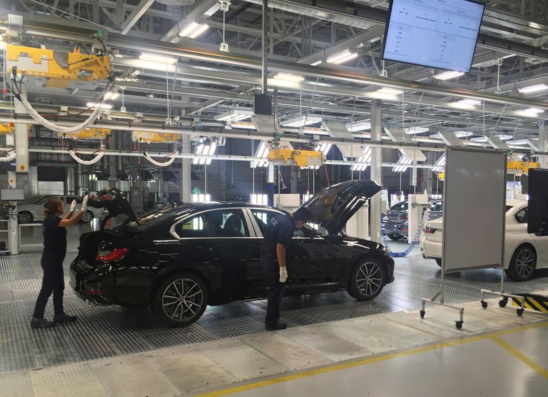 FILE PHOTO: Employees work on a BMW 3 Series car
