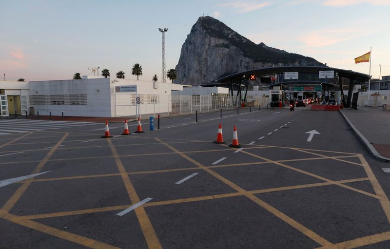 Drivers cross the Gibraltar border from Spain  in La