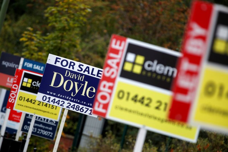 FILE PHOTO: Estate agents’ boards are displayed, amid the spread