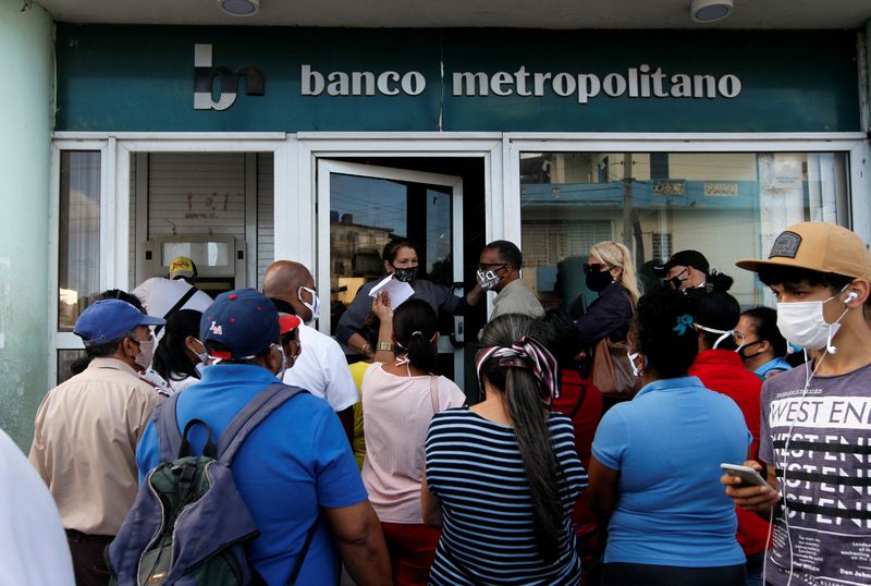 People stand outside a bank in Havana