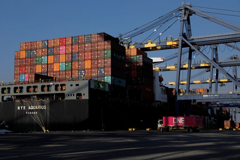 FILE PHOTO: Shipping containers are stacked on a ship docked