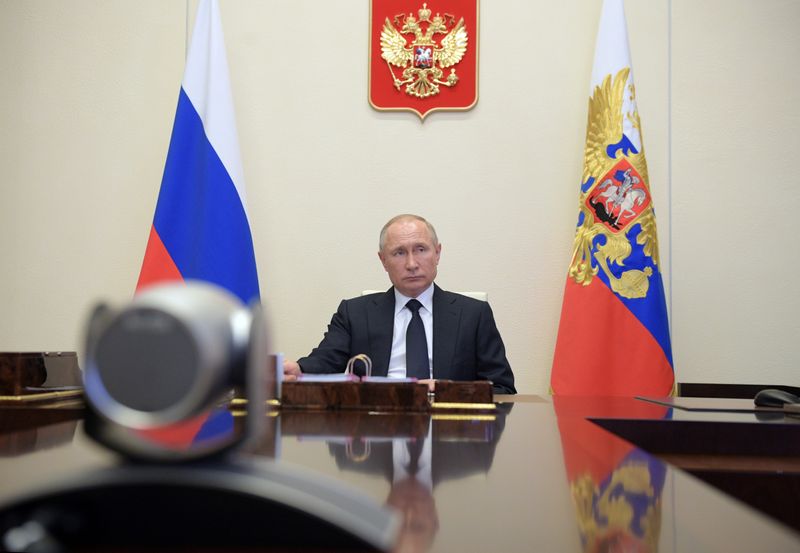 Russian President Putin chairs a meeting via video link outside