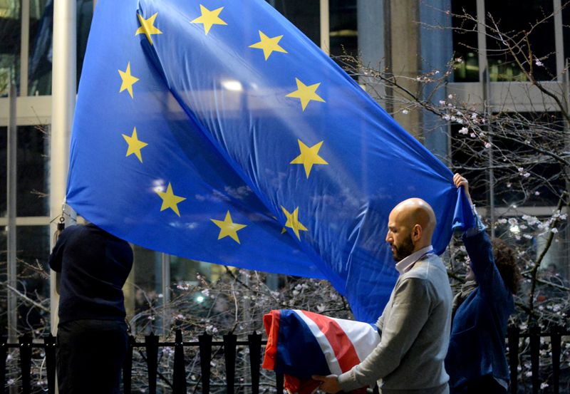 Workers replace the British flag outside the European Parliament building
