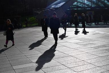 Commuters walk through Canary Wharf in London