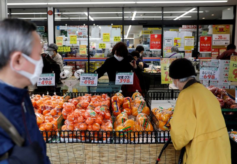Shoppers wearing protective face masks, following an outbreak of the