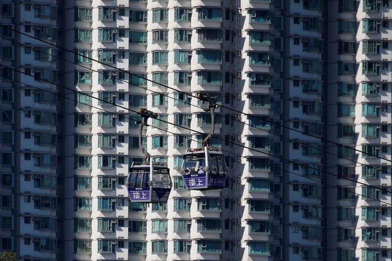 Cable cars move past residential flats at Lantau island in