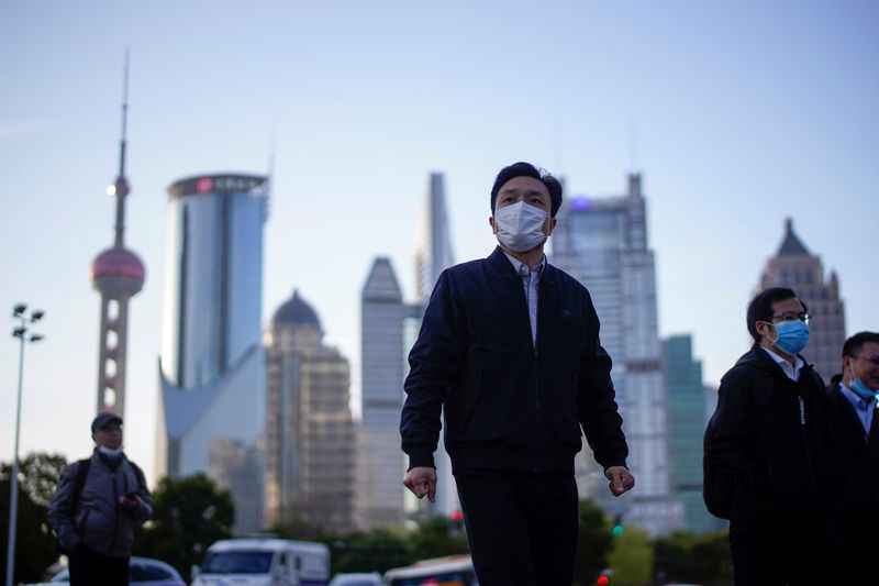 FILE PHOTO: People wear protective face masks, following an outbreak
