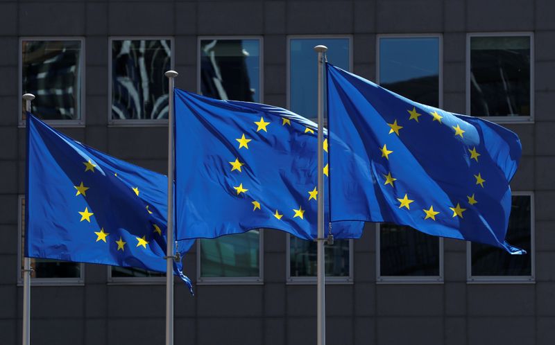 FILE PHOTO: European Union flags flutter outside the European Commission