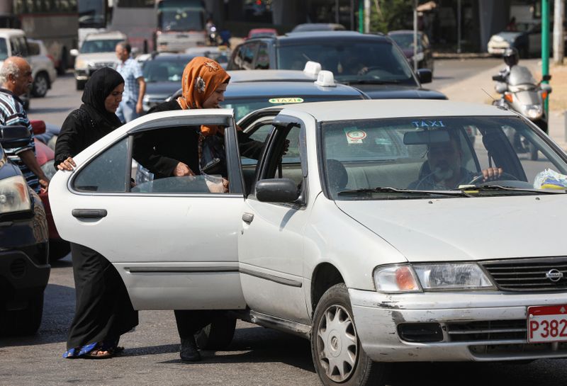 Women get into a taxi in Beirut