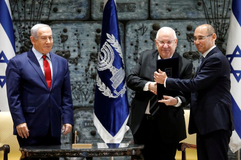 FILE PHOTO: Israeli Prime Minister Benjamin Netanyahu stands nearby as