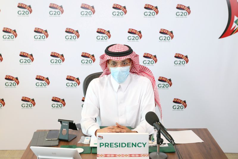 Saudi Minister of Finance Mohammed al-Jadaan wears a protective mask