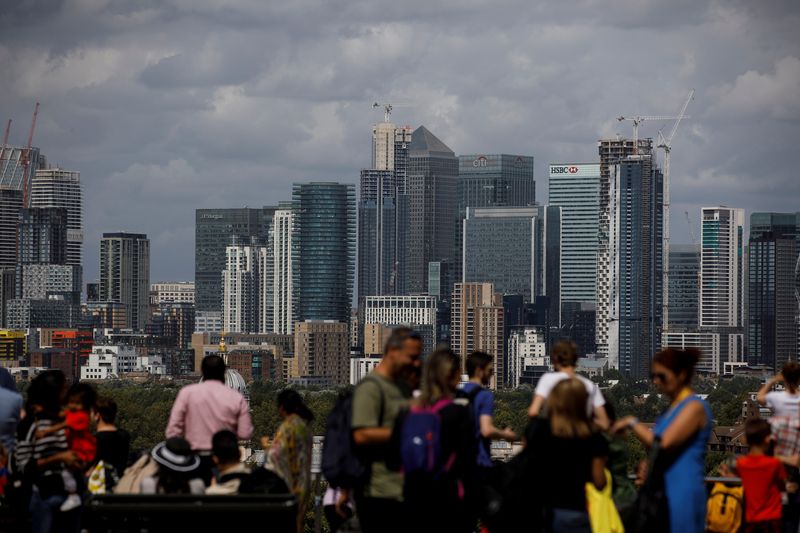 People look out onto the Canary Wharf financial district as
