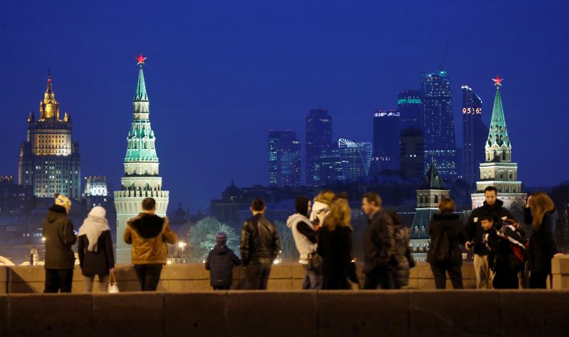 People stand on Great Moskvoretsky Bridge in central Moscow