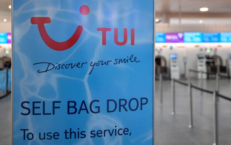 TUI sign is seen at the check-in area at Gatwick