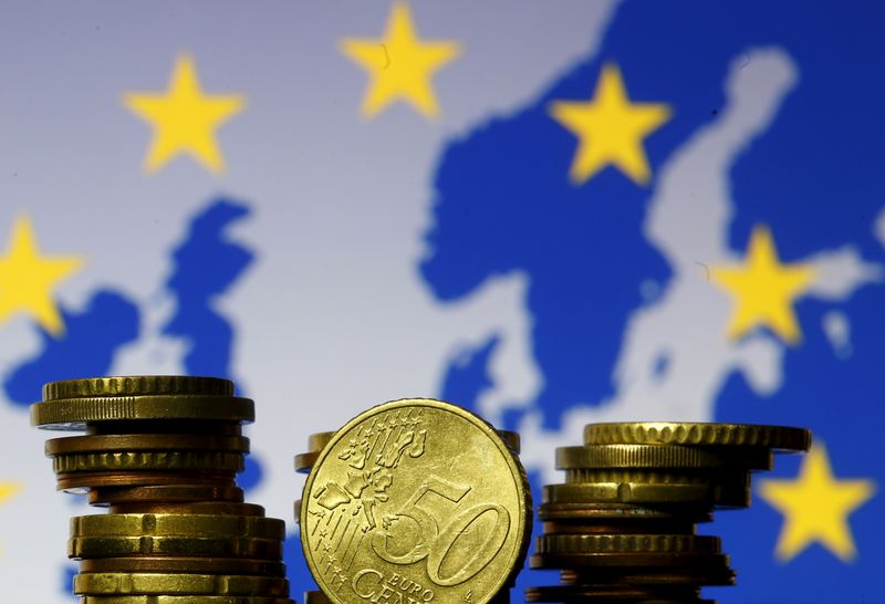 FILE PHOTO: Euro coins are seen in front of displayed