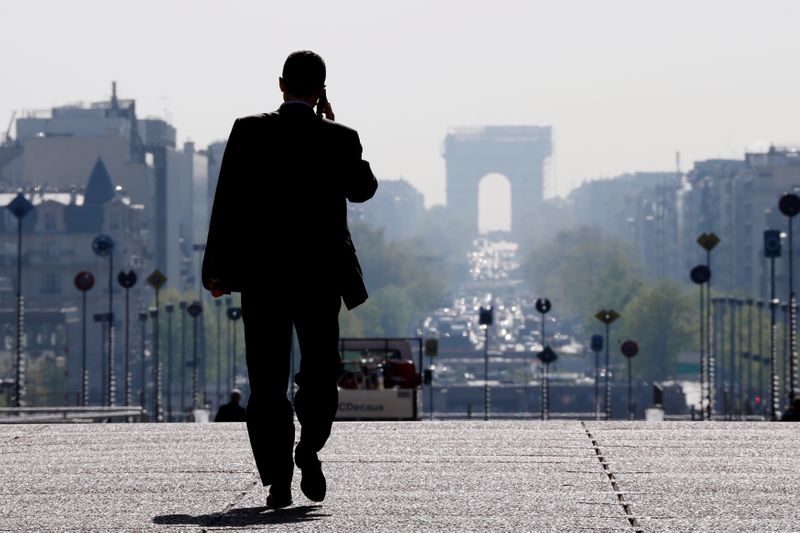 A businessman walks on the esplanade of La Defense, in