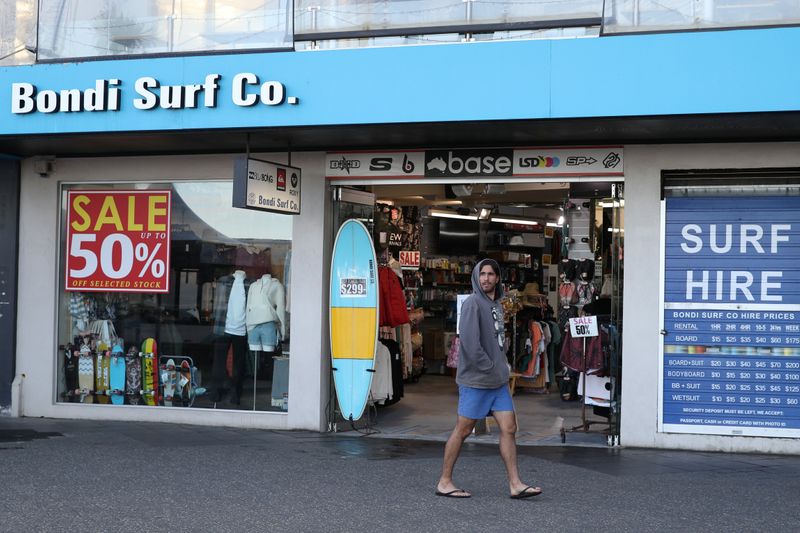 A man walks past a retail shop at Bondi Beach