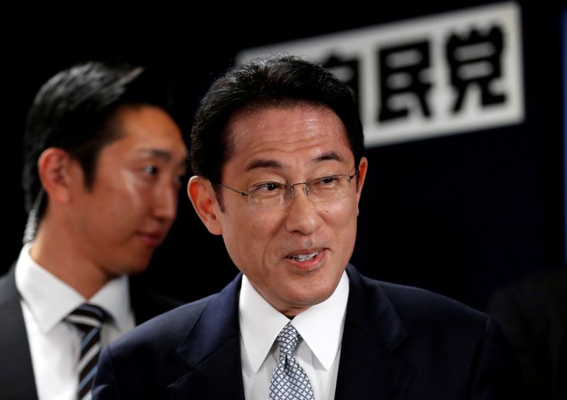 Japan’s ruling Liberal Democratic Party policy chief Kishida smiles as