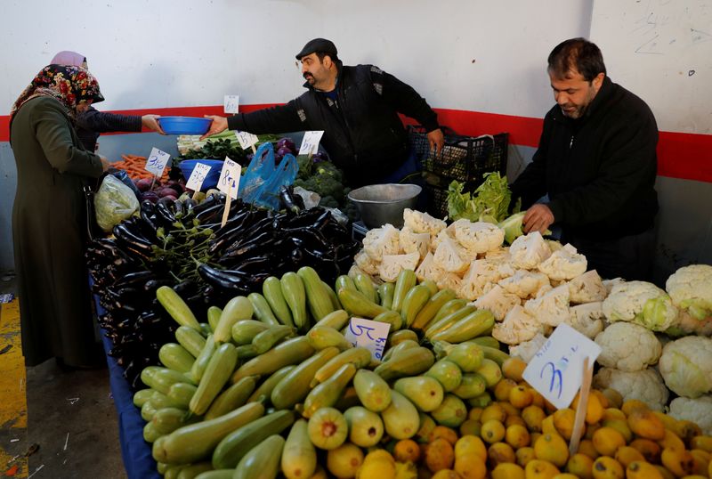 People shop at a food market in Istanbul