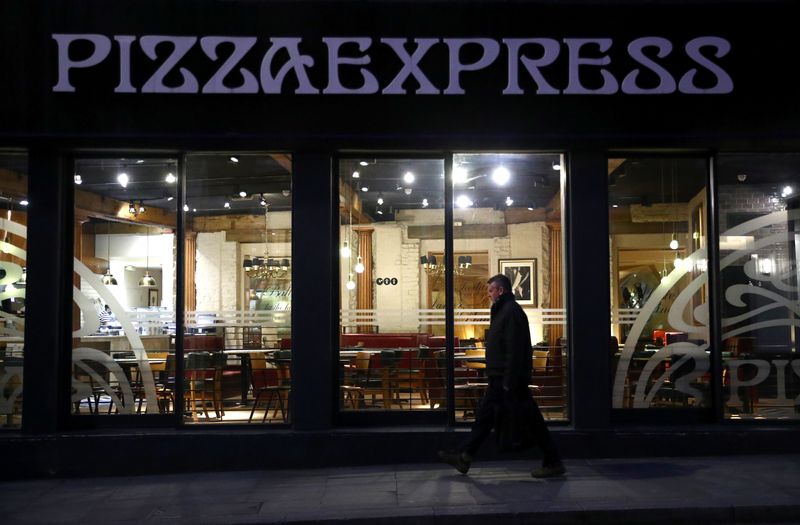A person is seen walking past an empty Pizza Express