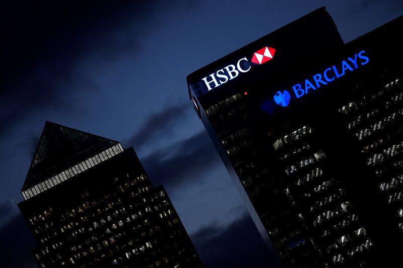 FILE PHOTO: HSBC and Barclay’s buildings are lit up at